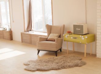 Armchair in a bright living room next to a guitar amp