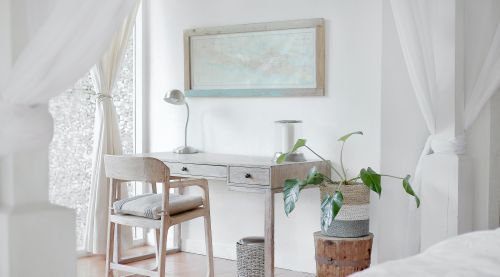 Bright bedroom with a small desk and chair