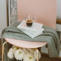 Coffee on stack of books on a chair